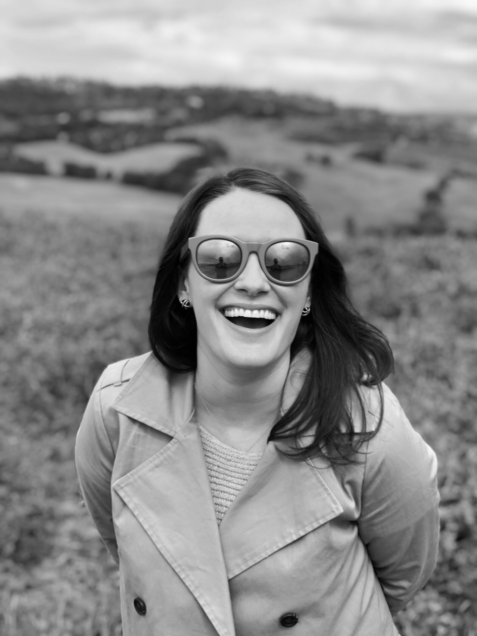 Deirdre Pelrin laughing outdoors in the countryside